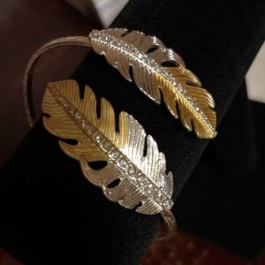 Gold and silver toned cuff feather bracelet